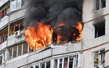 Flames come out of an appartement in a residential building of the northern outskirts of Kharkiv following shelling on April 22, 2022, as talks between Moscow and Kyiv to put an end to Russia's military campaign in Ukraine have "stalled", Russian Foreign Minister said.