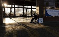 A police officer sits outside a polling station in Sandton, Johannesburg, on 1 November 2021, during South Africa's local elections. Picture: Guillem Sartorio/AFP