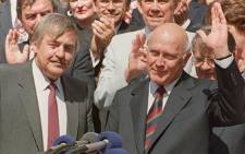 This file picture dated 18 March 1992 shows former South African President Frederik de Klerk (right), flanked by his Foreign Affairs Minister Pik Botha, acknowledging applause from the crowd after a referendum in Cape Town. Picture: AFP.
