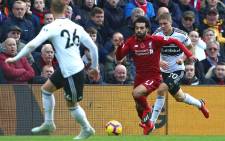 Liverpool's Egyptian midfielder Mohamed Salah (C) vies with Fulham's French defender Maxime Le Marchand (R) and Fulham's English defender Alfie Mawson (L) during the English Premier League football match between Liverpool and Fulham at Anfield in Liverpool, north west England on 11 November 2018. Picture: AFP