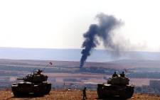 A picture taken from Turkey shows smoke rising after an airstrike by an alleged alliance war plane on the Islamic State targets in the west of Kobani, Syria, where Kurdish fighters YPG are trying to defend the city, near Suruc district, Sanliurfa, Turkey 08 October 2014. Picture: EPA/Sedat Suna.