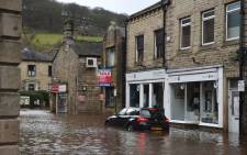 FILE: A car is seen submerged in floodwater in the streets of Hebden Bridge, northern England, on 9 February 2020, as Storm Ciara swept over the country. Picture: AFP.
