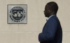 FILE: A man walks past the International Monetary Fund (IMF) headquarters in Washington DC. Picture: AFP