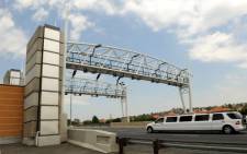 A limousine drives past a toll gantry along the N12 highway in Johannesburg. Picture: Werner Beukes/SAPA.