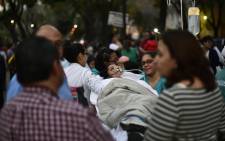 A patient is evacuated from a hospital during a powerful earthquake in Mexico City on 16 February 2018. Picture: AFP.