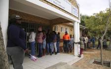 A small queue of voters standing outside the Hector Peterson Library in Lwandle waiting to vote on 8 May 2019. Picture: Cindy Archillies/EWN