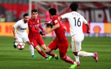 Shanghai SIPG's Brazilian midfielder Oscar (2nd L) during a Chinese Super League match against Changchun Yatai. Picture: AFP