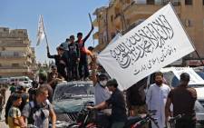 Members of Syria's top jihadist group the Hayat Tahrir al-Sham (HTS) alliance, led by al-Qaeda's former Syria affiliate, parade with their flags and those of the Taliban's declared "Islamic Emirate of Afghanistan" through the rebel-held northwestern city of Idlib on August 20, 2021. The armed group that formally broke ties with al-Qaeda years ago is considered to be the most prominent jihadist group in Syria after a decade of war. HTS controls nearly half of the Idlib region -- the last remaining opposition bastion in Syria -- alongside other less influential groups.
OMAR HAJ KADOUR / AFP