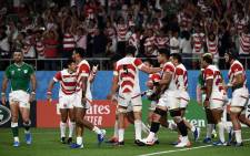 Japan's wing Kenki Fukuoka (C, hidden) celebrates with teammates after scoring a try during the Japan 2019 Rugby World Cup Pool A match between Japan and Ireland at the Shizuoka Stadium Ecopa in Shizuoka on 28 September 2019. Picture: AFP