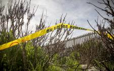 Police tape at a cordoned off area in Lavender Hill, where a body necklaced, was found. Picture: Thomas Holder/EWN.