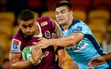 FILE: The Reds' Lukhan Salakaia-Loto (L) is tackled by Waratahs' Jack Maddocks (R) during the Super Rugby match between Australia's Queensland Reds and the New South Wales Waratahs at Suncorp Stadium in Brisbane on 3 July 2020. Picture: AFP