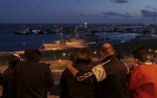A family looks at Argentine Navy destroyer 'ARA Sarandi' docked at Argentina's Navy base in Mar del Plata, on the Atlantic coast south of Buenos Aires on November 20, 2017 during a search for an Argentine submarine. Picture: AFP.