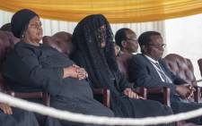 Robert Mugabe’s family including his wife, Grace (veiled,) sits and watches on as members of the public view the body of the former president. Picture: Thomas Holder/EWN