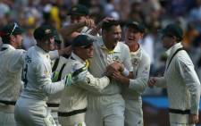 Australia's paceman Scott Boland (C) celebrates his wicket of England's batsman Jack Leach (not pictured) with teammates on day two of the third Ashes cricket Test match between Australia and England in Melbourne on 27 December 2021. Picture: Hamish Blair/AFP