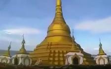 A YouTube screenshot of a Buddhist temple in central Myanmar being swallowed by rising floodwaters after heavy rainfall.