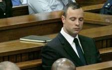 Oscar Pistorius closes his eye as he sits in the dock after testifying at the High Court in Pretoria on 15 April 2014. 