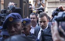 Oscar Pistorius arriving under heavy police guard at the High Court in Pretoria ahead of judgment in his murder trial on 12 September 2014. Picture: Christa Eybers/EWN.