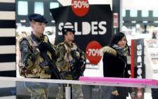 French soldiers patrol in a shopping center in Lyon on 16 January, 2015 , after France announced an unprecedented deployment of thousands of troops. Picture: AFP.