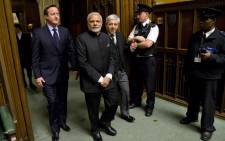 British Prime Minister David Cameron and Britains Speaker of the House of Commons John Bercow (3R)accompany Indian Prime Minister Narendra Modi (2L on a tour of The Commons Chamber inside the Houses of Parliament in central London on 12 November, 2015. Picture: AFP.