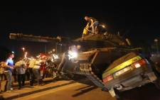 FILE: A tank crashes against a car as people take to the streets in Ankara, Turkey, during a protest against a military coup. Picture: AFP.