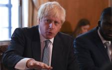 FILE: Britain's Prime Minister Boris Johnson (L) speaks flanked by Youth Justice Board Adviser Roy Sefa-Attakora (R) during a roundtable on the criminal justice system at 10 Downing Street in London on 12 August 2019. Picture: AFP