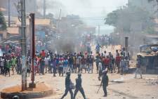 Protesters clash with anti-riot police in a street in Conakry, Guinea on 13 March 13, 2018 during a demonstration against President Alpha Conde. Demonstrators erected roadblocks and set fire to tyres, during the protest. Picture: AFP