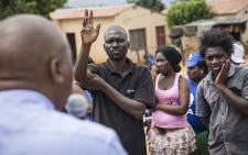 A Kaalfontein resident puts up his hand to ask DA mayoral candidate for Johannesburg Herman Mashaba a question during his visit to the community on 17 February 2016. Picture: Reinart Toerien/EWN.