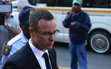 Oscar Pistorius is escorted into High Court in Pretoria ahead of his murder trial on 17 March 2014. Picture: Aletta Gardner/EWN.