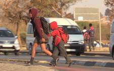 School children cross Chris Hani Road in Soweto on their way to school. The road has been the scene of many fatal incidents over the years. Picture: Vumani Mkhize/EWN.