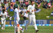 New Zealand’s Trent Boult (R) celebrates South Africa’s Temba Bavuma being caught during day two of the 1st International cricket Test match between New Zealand and South Africa at the University Oval in Dunedin on 9 March, 2017. Picture: AFP.