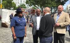 Cape Town Mayor Dan Plato and Cape Town Central Police Station commander Brigadier Hansia Hansraj speak with business owners at Green Market Square during a walkabout in the City Centre. Picture: Kevin Brandt/EWN