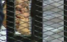 Former Egyptian president Hosni Mubarak is wheeled into a holding cell in the court room in the police academy in Cairo where he faces murder charges on 03 August 2011. AFP