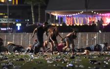 People run from the Route 91 Harvest country music festival after apparent gun fire was heard on 1 October 2017 in Las Vegas, Nevada. Picture: AFP