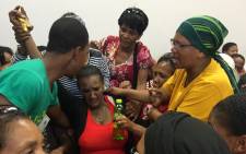 Beatrice Adams (in red), the mother of the murdered Michaela Williams is helped in the Wynberg Magistrates Court after suffering a panic attack on 13 January 2020. Picture: Lauren Isaacs/EWN