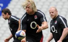 FILE:England's lock Mouritz Botha (C) passes the ball during a training session at the Stade de France in Saint-Denis, north of Paris, on March 10, 2012, on the eve of their rugby union 6 Nations tournament match against England. Picture: AFP.