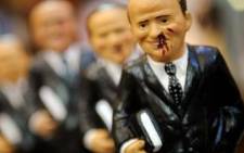 Figurines poking fun at Italian leader Silvio Berlusconi are on sale in Naples. He was recently attacked in public. Picture: AFP Photo