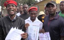 FILE: EFF members hold ballot papers they claim to have found at the entry of an Alexandra IEC office. The suspect vote rigging in the area. Picture:Vumani Mkhize/EWN