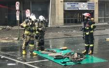 Firefighters begin clearing away equipment on 7 September 2018 near the Lisbon Building following the deadly fire there earlier this week. Picture: Christa Eybers/EWN