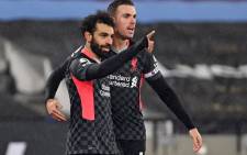 Liverpool's Mohamed Salah (L) celebrates with teammate Jordan Henderson (R) after scoring their second goal during the English Premier League football match between West Ham United and Liverpool at The London Stadium, in east London on 31 January 2021. Picture: Justin Setterfield/AFP