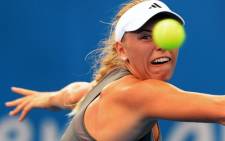 Caroline Wozniacki of Denmark keeps her eye on the ball in her match against Ksenia Pervak of Kazakhstan in the first round at the Brisbane International tennis tournament on 31 December, 2012. Picture: AFP