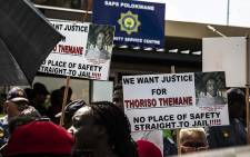 Residents outside Polokwane Police Station with banners marked ‘Justice for Thoriso’. Picture: Kayleen Morgan/EWN. 