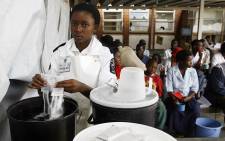 FILE: A nurse at the Budiriro Polyclinic prepares a sugar solution for patients in Harare. Picture: AFP