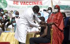 The Minister of Health and Social Action, Abdoulaye Diouf Sarr (C) gets vaccinated - as the first one in Senegal - during the official launch of the vaccination campaign against the COVID-19, in Dakar, on February 23, 2021. Picture: Seyllou / AFP.
