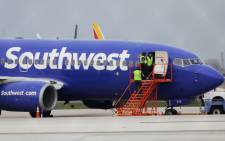 A Southwest Airlines jet sits on the runway at Philadelphia International Airport after it was forced to land with an engine failure, in Philadelphia, Pennsylvania, on 17 April 2018. Picture: AFP