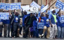 Democratic Alliance supporters voice their disapproval over the e-tolling system outside the North Gauteng High Court in Pretoria on Tuesday, 24 April 2012 where the system is being challenged. Picture:Sapa.