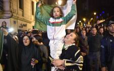 FILE: Algerians celebrate after Algeria's veteran President Abdelaziz Bouteflika informed the Constitutional Council that he is resigning in Algiers on 2 April 2019.
