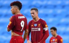 Liverpool's Roberto Firmino (L), Jordan Henderson (C) and Trent Alexander-Arnold (R) react after they concede their third goal during the English Premier League football match between Manchester City and Liverpool at the Etihad Stadium in Manchester, north west England, on 2 July 2020. Picture: AFP