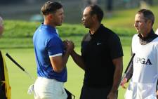 FILE: In this file photo taken on 16 May 2019, Brooks Koepka of the United States and Tiger Woods of the United States shake hands on the 18th green during the second round of the 2019 PGA Championship at the Bethpage Black course in Farmingdale, New York. Picture: AFP