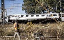 A PRASA (Passenger Rail Agency of South Africa) official stands next to the wreckage of two trains which collided near the Elandsfontein station in Johannesburg on Thursday morning leaving one person dead and over 100 injured. Picture: Reinart Toerien/EWN