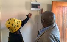 Eskom officials switched on the electricity at one of the residents’ homes in Delft on 11 April 2022. Picture: Kaylynn Palm/EWN.
